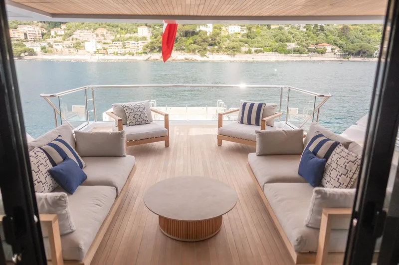 Tolemai Yacht Photos Pics Luxurious Sanlorenzo XSP202 yacht deck with elegant seating, overlooking serene waters, 2023 model.