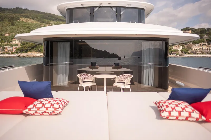 Tolemai Yacht Photos Pics Luxurious 2023 Sanlorenzo XSP202 yacht deck with stylish seating and scenic coastal view.