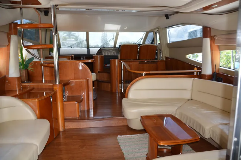 B&t Escape Yacht Photos Pics Luxurious interior of a 2005 Princess 61 yacht with elegant wood and leather furnishings.