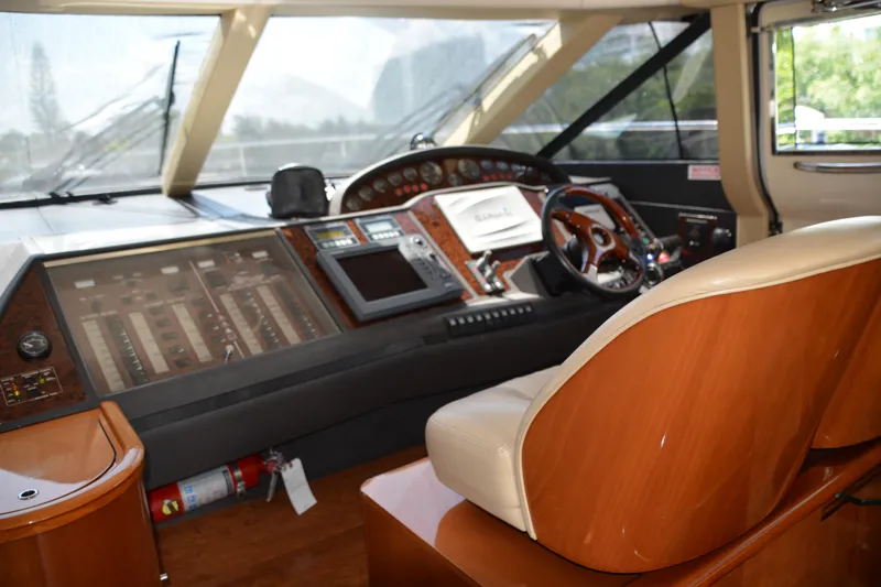 B&t Escape Yacht Photos Pics Cockpit of a 2005 Princess 61 yacht with control panels and steering wheel.