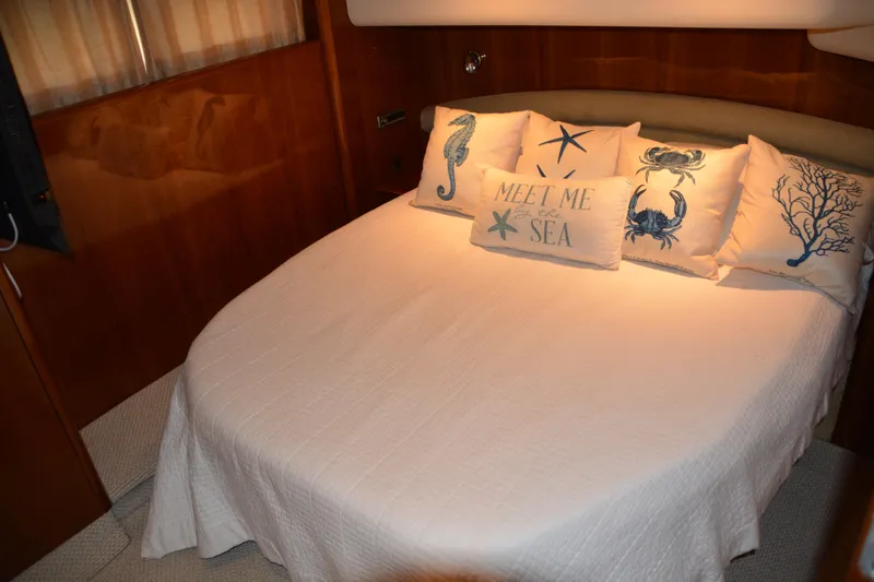 B&t Escape Yacht Photos Pics Luxurious cabin interior of 2005 Princess 61 yacht with nautical-themed bedding.