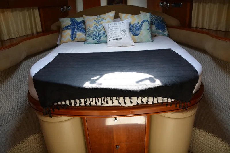 B&t Escape Yacht Photos Pics Luxurious 2005 Princess 61 yacht bedroom with starfish-themed pillows and elegant bedding.