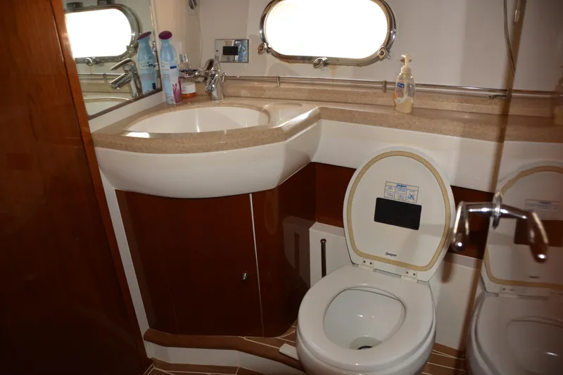 B&t Escape Yacht Photos Pics Luxurious bathroom in 2005 Princess 61 yacht with modern fixtures and wooden accents.