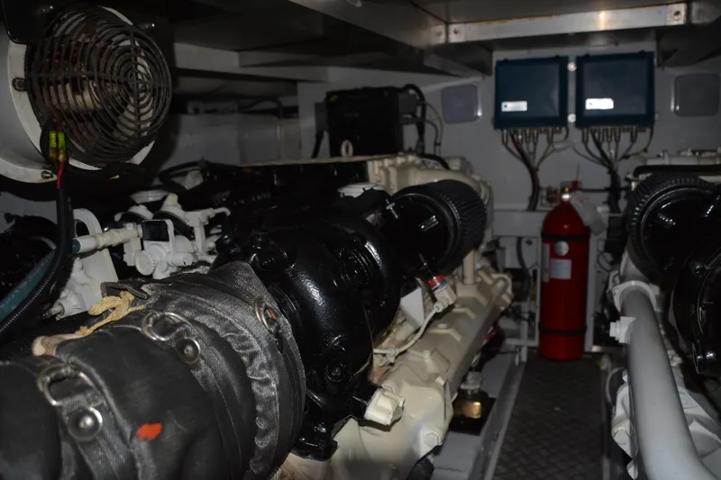 B&t Escape Yacht Photos Pics Engine room of a 2005 Princess 61 yacht, featuring machinery and fire extinguisher.
