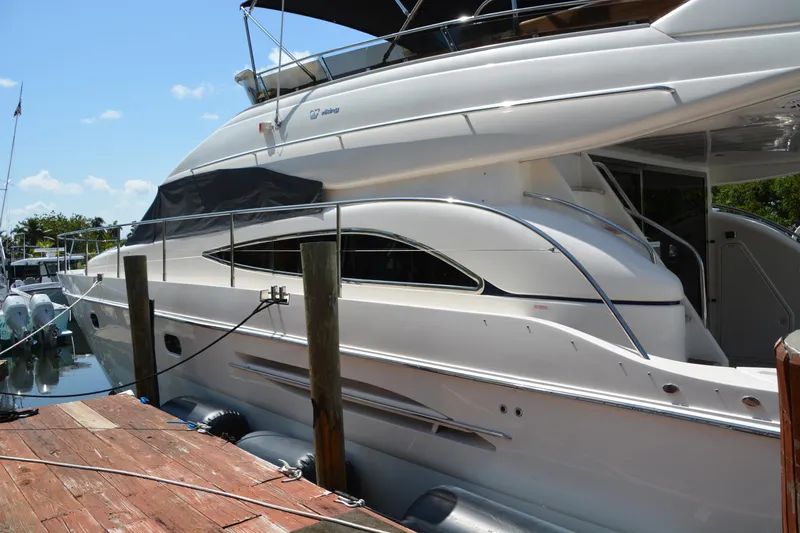 B&t Escape Yacht Photos Pics Luxury 2005 Princess 61 yacht docked at marina under clear blue sky.