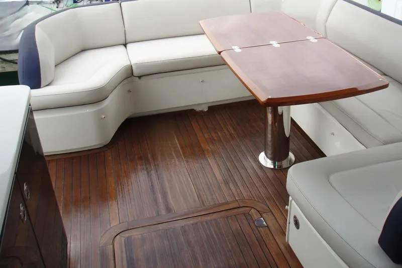 Off Season Yacht Photos Pics Luxurious 2015 Princess V48 yacht interior with elegant seating and wooden table.