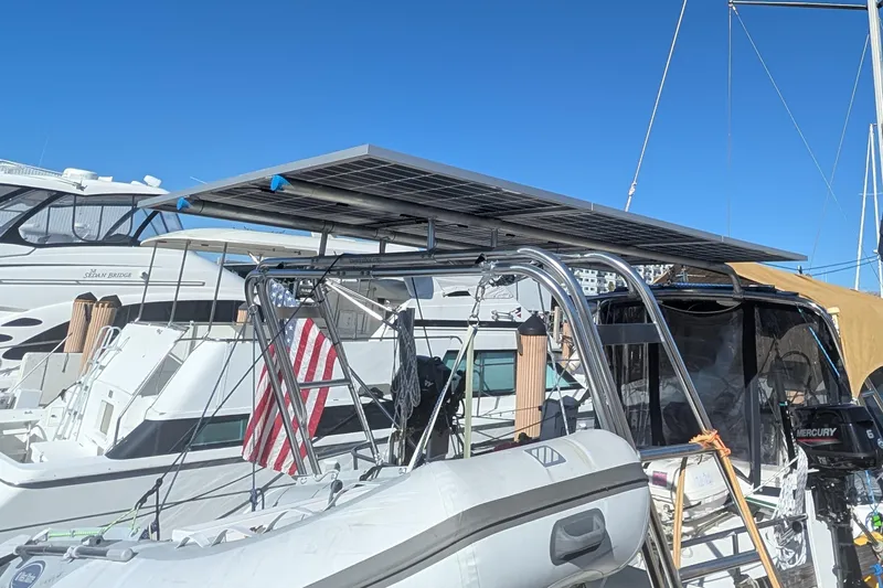 'mystic Cay' Yacht Photos Pics 2002 Hunter 450 Passage yacht with solar panels and American flag in marina.