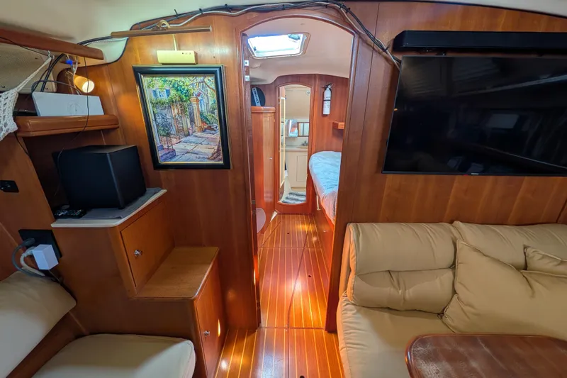 'mystic Cay' Yacht Photos Pics Interior of 2002 Hunter 450 Passage yacht with cozy seating and wooden finishes.