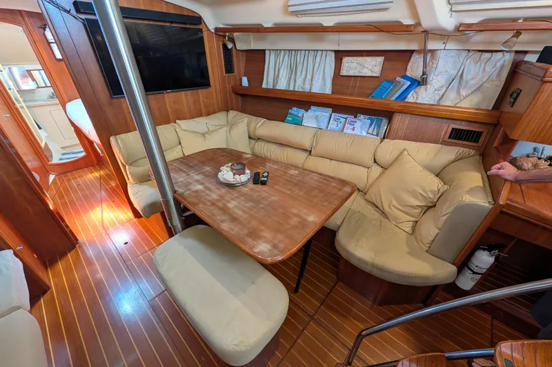 'mystic Cay' Yacht Photos Pics Luxurious interior of 2002 Hunter 450 Passage yacht with cozy seating and wooden finishes.