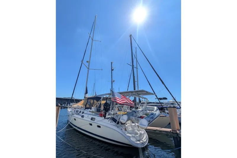 'mystic Cay' Yacht Photos Pics Sailboat Hunter 450 Passage 2002 docked under bright sun with American flag.