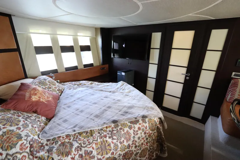  Yacht Photos Pics Luxurious bedroom interior of 2007 Azimut 62S yacht with floral bedding and modern decor.