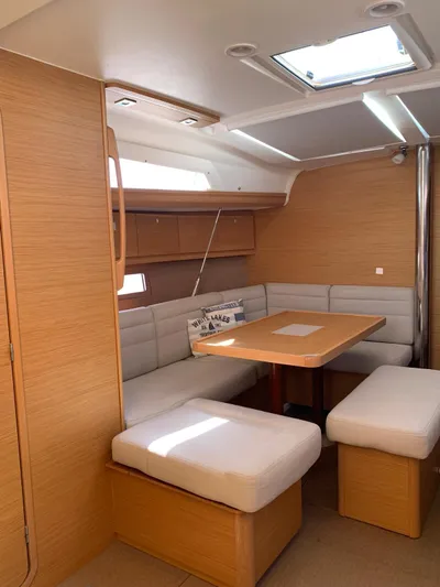  Yacht Photos Pics Interior of 2016 Dufour 410 Grand Large yacht with cozy seating and wooden finishes.