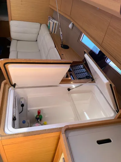  Yacht Photos Pics Interior of 2016 Dufour 410 Grand Large yacht with open storage and seating area.