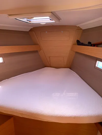  Yacht Photos Pics Cozy cabin interior of 2016 Dufour 410 Grand Large sailboat with natural wood finish.