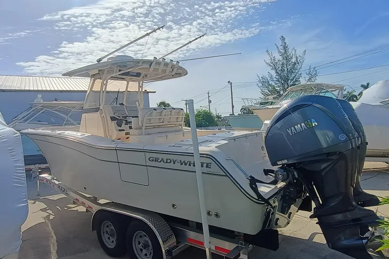 271-508 Brokerage Joe Yacht Photos Pics 2023 Grady-White Canyon 271 boat with Yamaha engine on trailer, under clear sky.