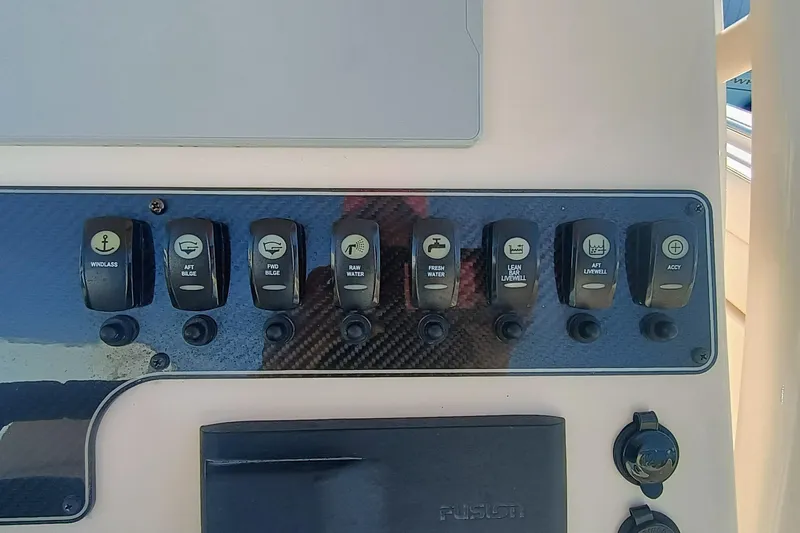 271-508 Brokerage Joe Yacht Photos Pics Control panel of 2023 Grady-White Canyon 271 boat with various switches.