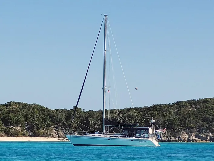 Bella Vita Yacht Photos Pics Sailboat Catalina 42 MkII 1999 anchored in clear blue water near a sandy beach.