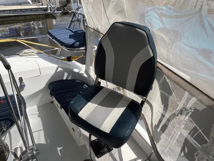 Bella Vita Yacht Photos Pics Captain's chair on a 1999 Catalina 42 MkII sailboat, featuring striped upholstery.