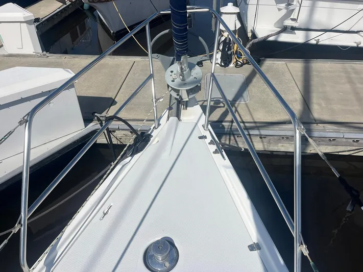 Bella Vita Yacht Photos Pics Bow of a 1999 Catalina 42 MkII sailboat docked at a marina.