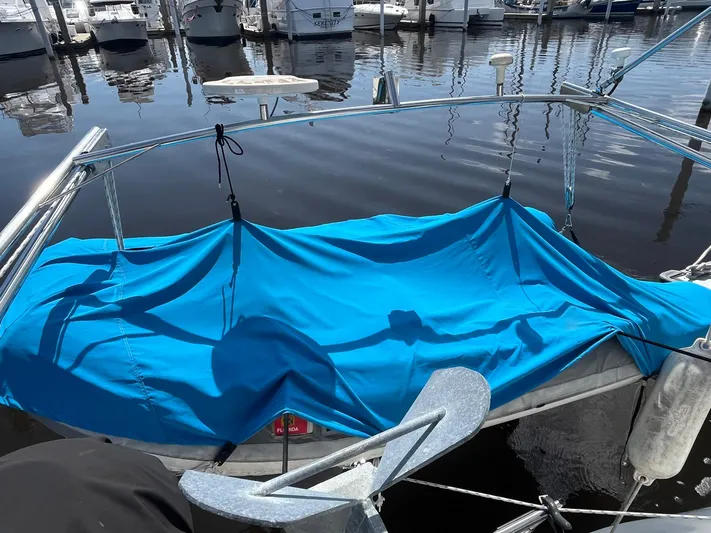 Bella Vita Yacht Photos Pics Blue tarp covering a section of a 1999 Catalina 42 MkII sailboat at a marina.