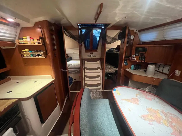 Bella Vita Yacht Photos Pics Interior of a 1999 Catalina 42 MkII sailboat with cozy living space and navigation table.
