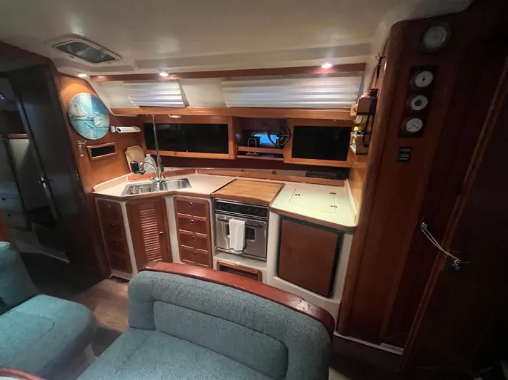 Bella Vita Yacht Photos Pics Interior of 1999 Catalina 42 MkII yacht, featuring a cozy kitchen and seating area.
