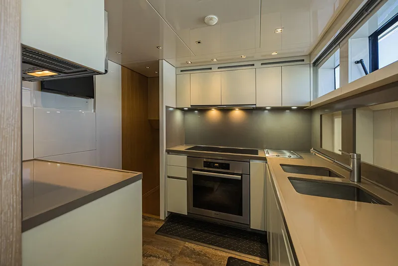 Percal Yacht Photos Pics Modern kitchen interior on 2014 Sanlorenzo SL104 yacht, featuring sleek cabinetry and stainless steel appliances.