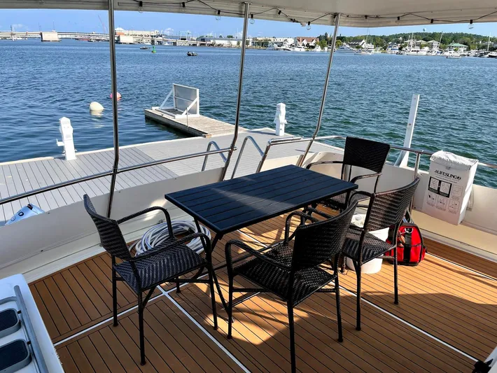  Yacht Photos Pics Outdoor seating on 1991 Hatteras 40 Motor Yacht, overlooking marina with dock and calm waters.