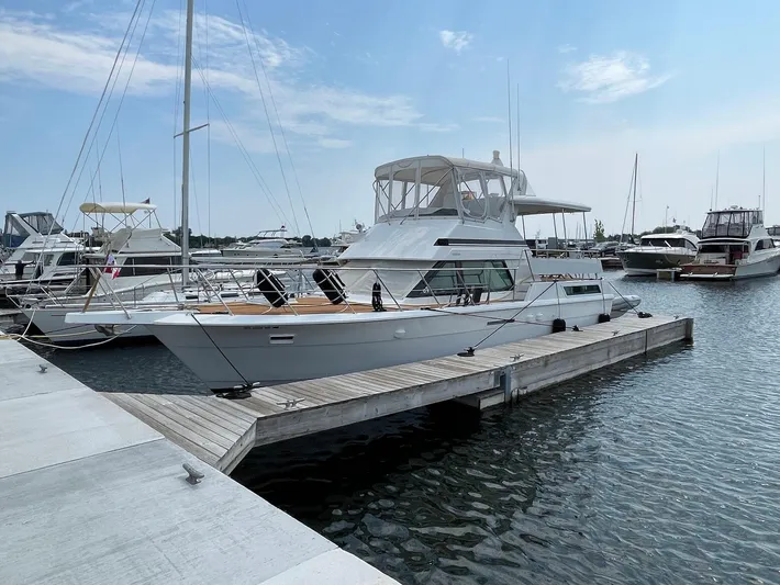  Yacht Photos Pics 1991 Hatteras 40 Motor Yacht docked at a marina under a clear blue sky.