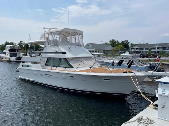  Yacht Photos Pics 1991 Hatteras 40 Motor Yacht docked at a marina under a clear sky.