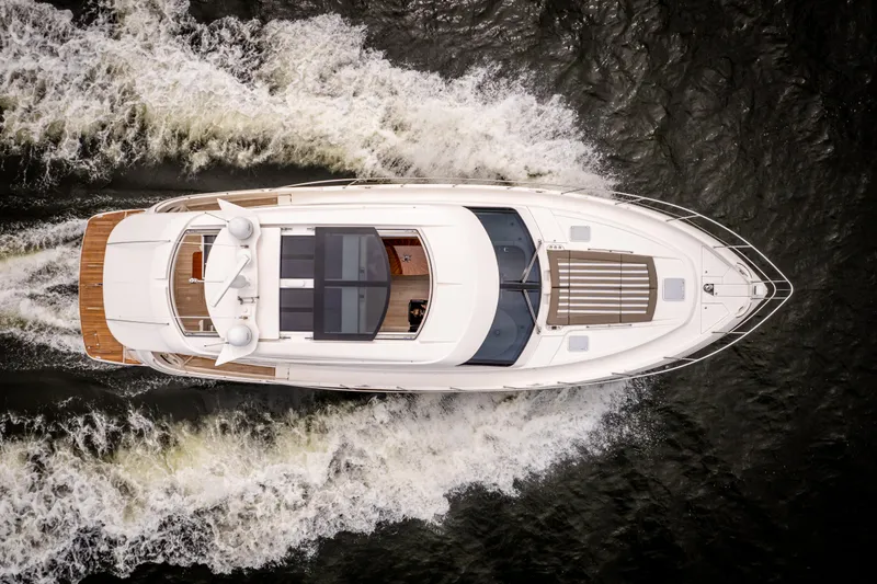 Change Happens Yacht Photos Pics Aerial view of 2017 Riviera 6000 Sport Yacht cruising on water.