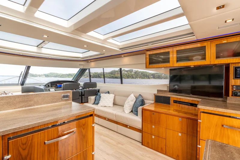 Change Happens Yacht Photos Pics Luxurious interior of 2017 Riviera 6000 Sport Yacht with modern furnishings and panoramic windows.