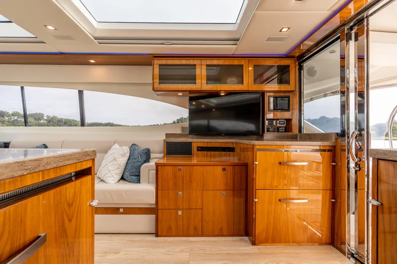 Change Happens Yacht Photos Pics Luxurious interior of 2017 Riviera 6000 Sport Yacht with wood cabinetry and modern amenities.