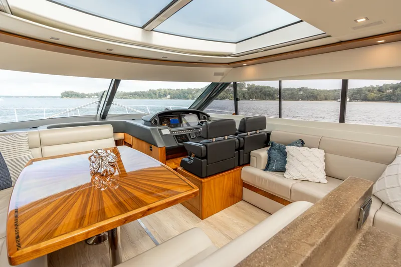 Change Happens Yacht Photos Pics Luxurious interior of 2017 Riviera 6000 Sport Yacht with elegant seating and panoramic windows.