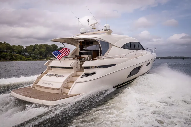 Change Happens Yacht Photos Pics 2017 Riviera 6000 Sport Yacht cruising on water with American flag.