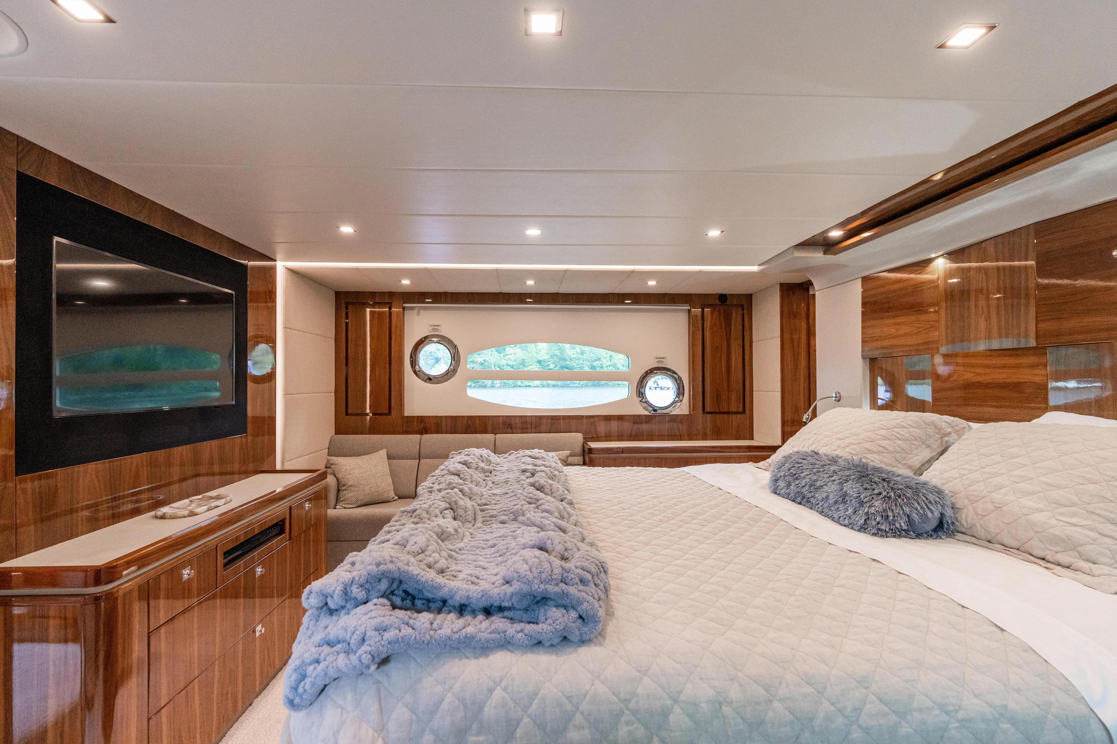 Change Happens Yacht Photos Pics Luxurious interior of 2017 Riviera 6000 Sport Yacht with elegant wood finishes and plush bedding.