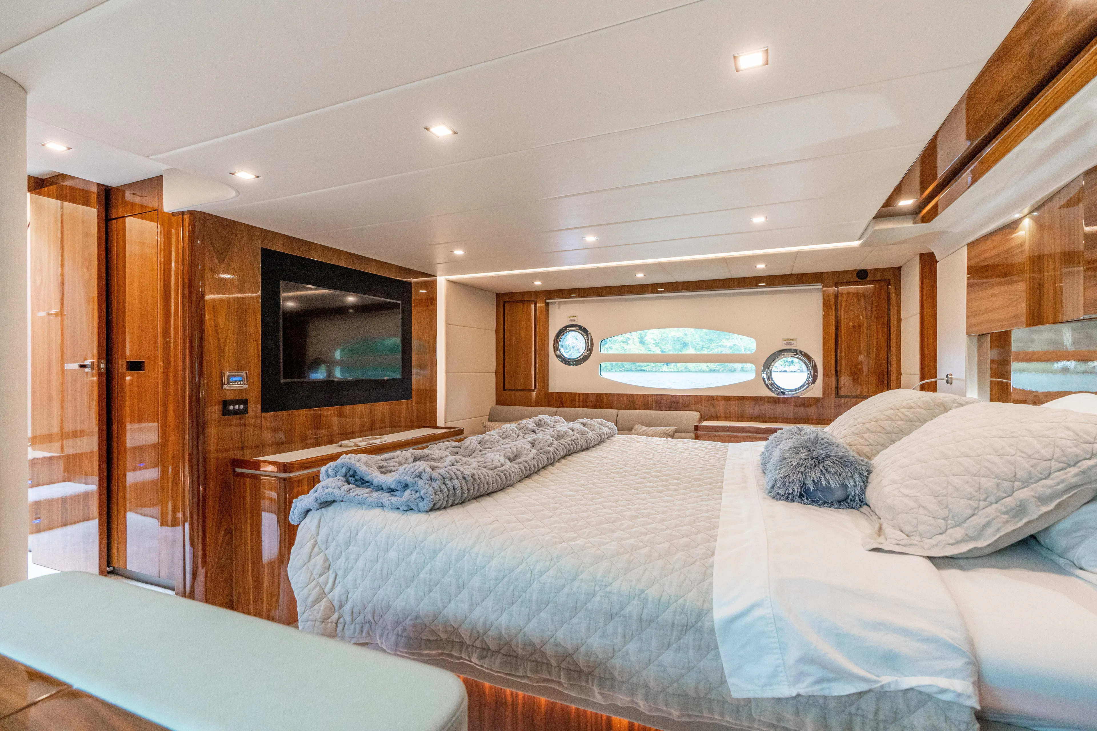 Change Happens Yacht Photos Pics Luxurious bedroom interior of 2017 Riviera 6000 Sport Yacht with elegant wood finishes.