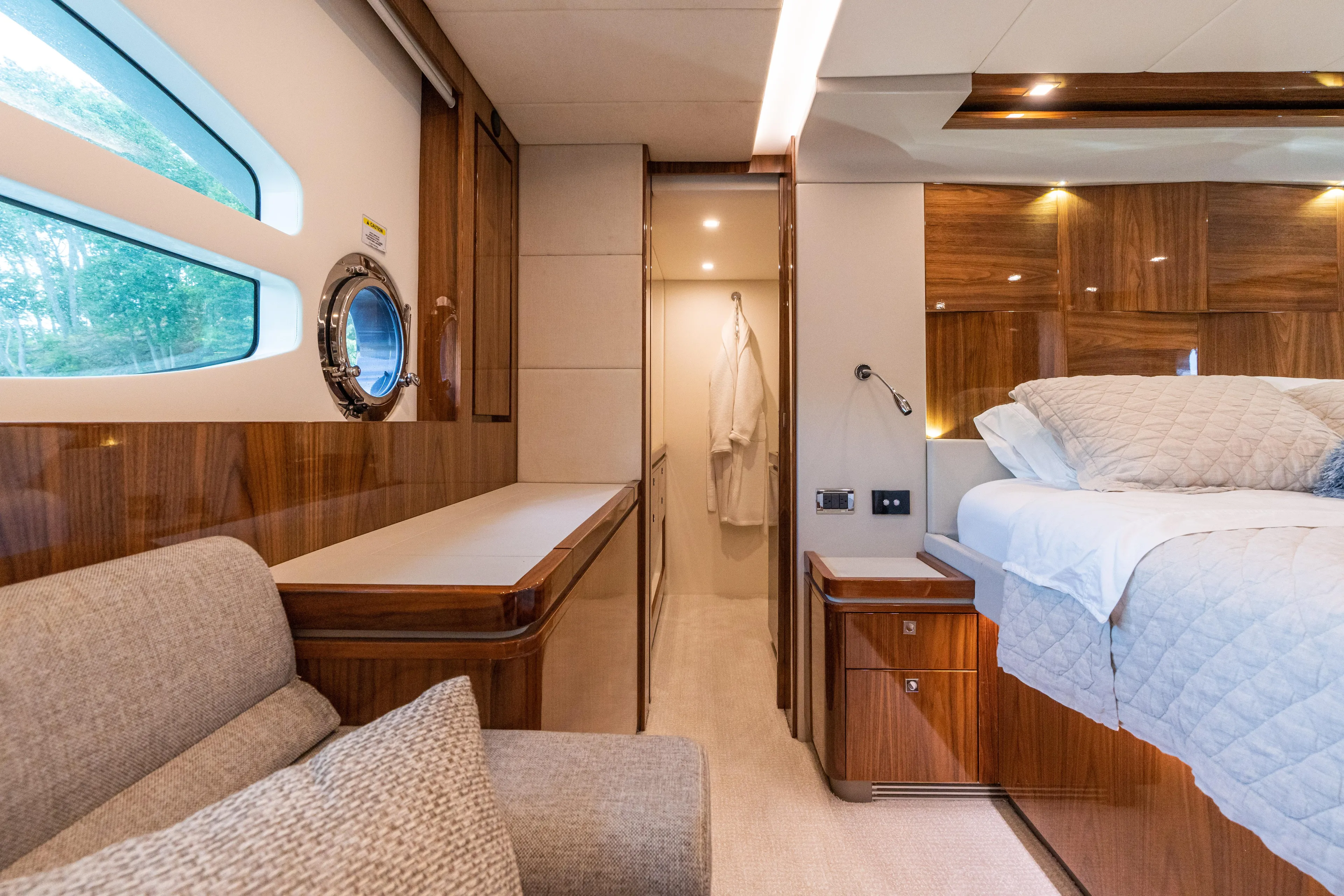 Change Happens Yacht Photos Pics Luxurious interior of 2017 Riviera 6000 Sport Yacht with elegant wood finishes and plush bedding.
