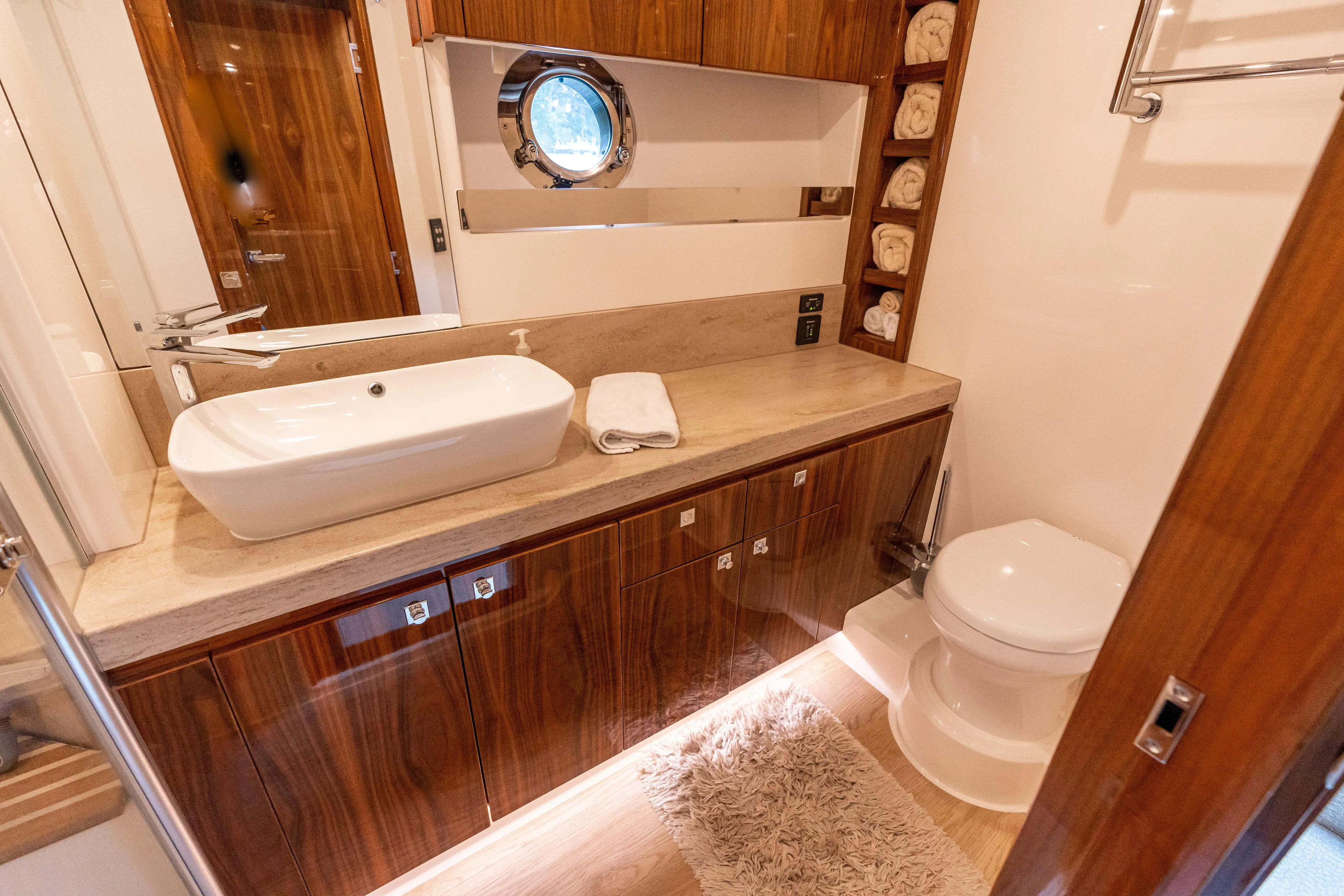 Change Happens Yacht Photos Pics Luxurious bathroom in 2017 Riviera 6000 Sport Yacht with modern sink and wooden cabinetry.