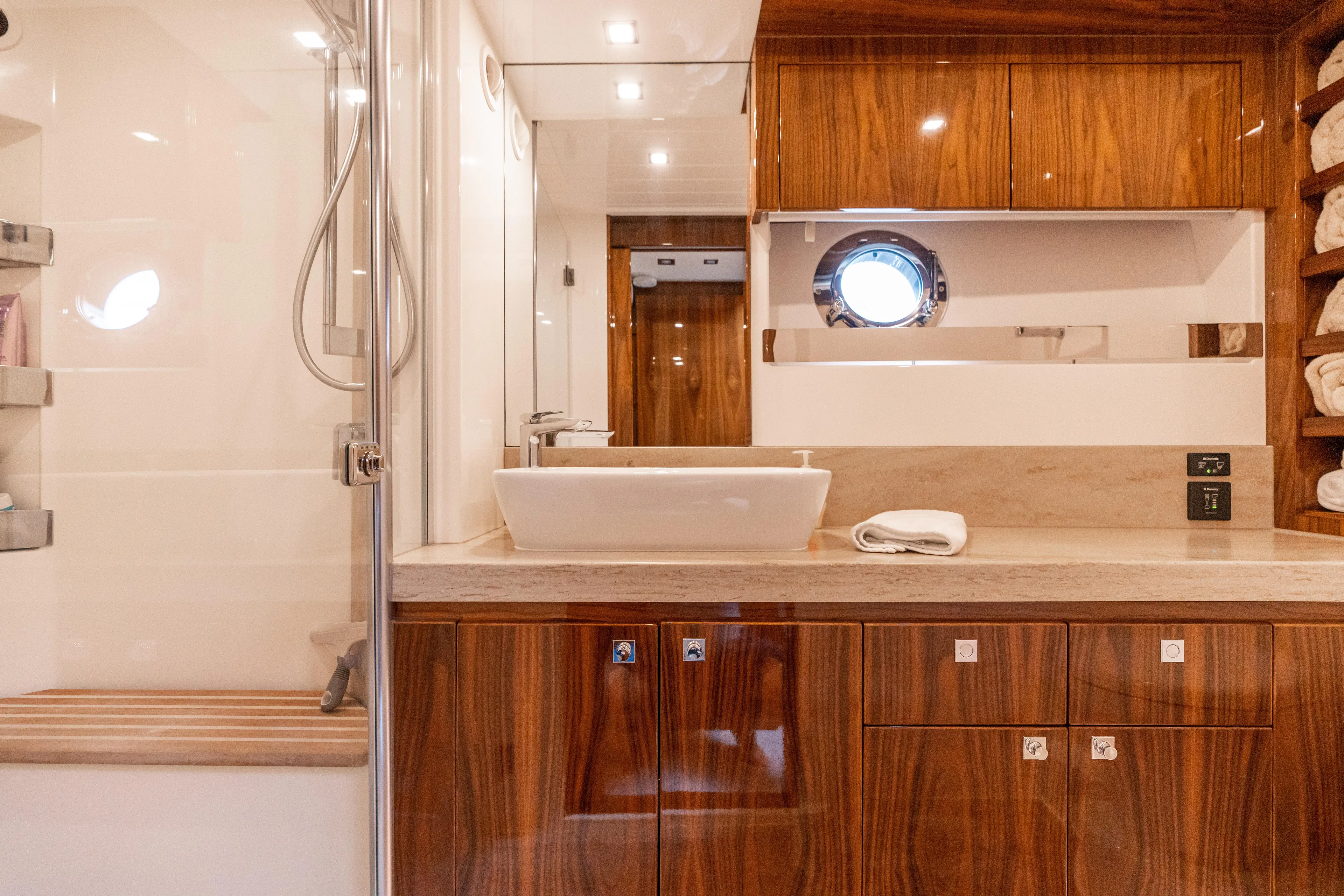 Change Happens Yacht Photos Pics Luxurious bathroom in 2017 Riviera 6000 Sport Yacht with wood accents and modern fixtures.