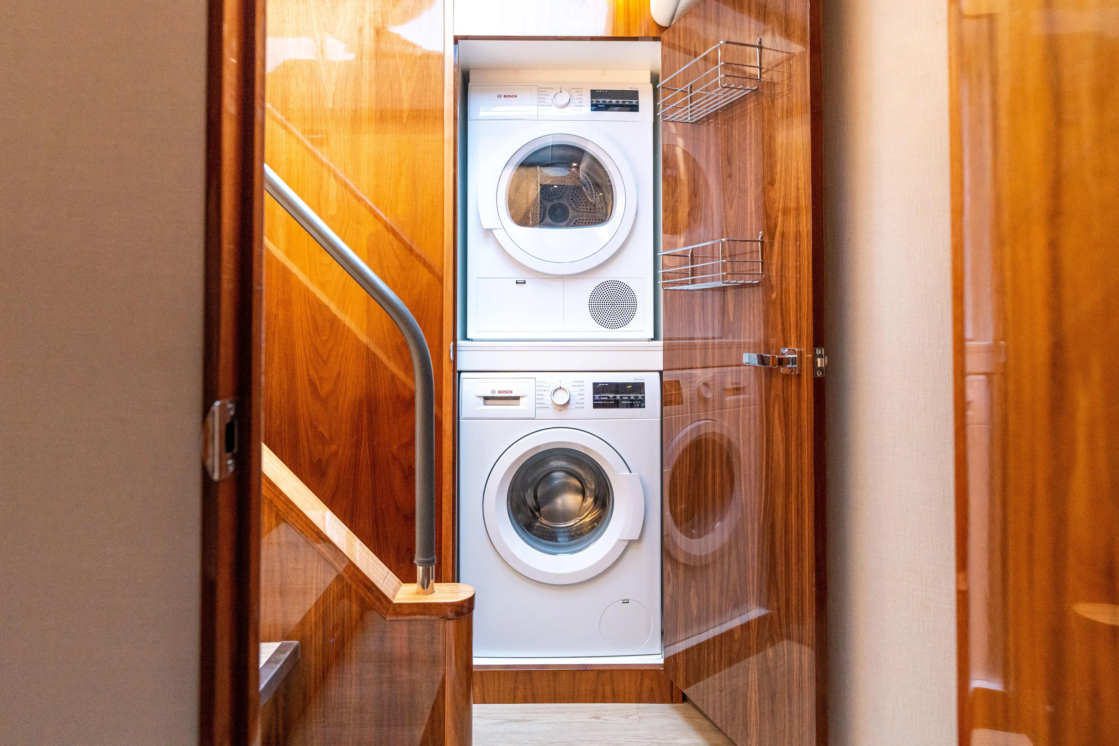 Change Happens Yacht Photos Pics Laundry area with stacked washer and dryer in 2017 Riviera 6000 Sport Yacht.