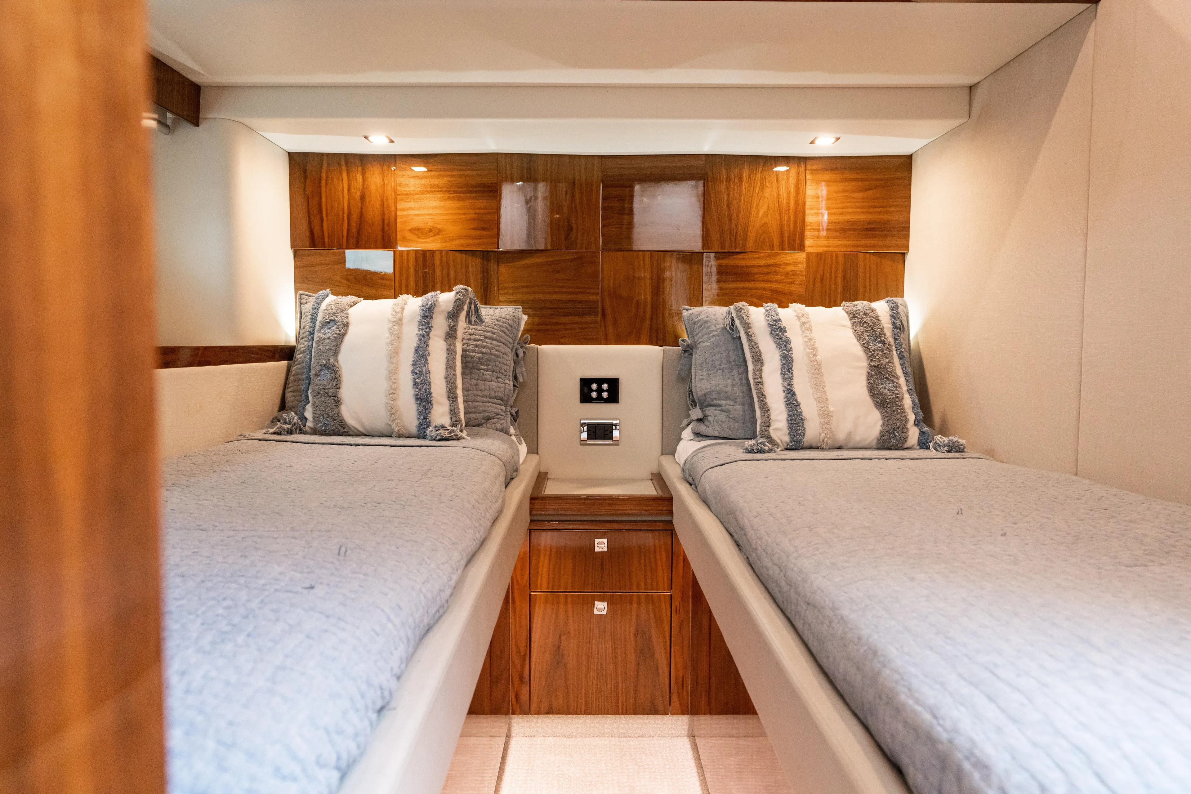 Change Happens Yacht Photos Pics Luxurious twin cabin in 2017 Riviera 6000 Sport Yacht with elegant wood paneling.