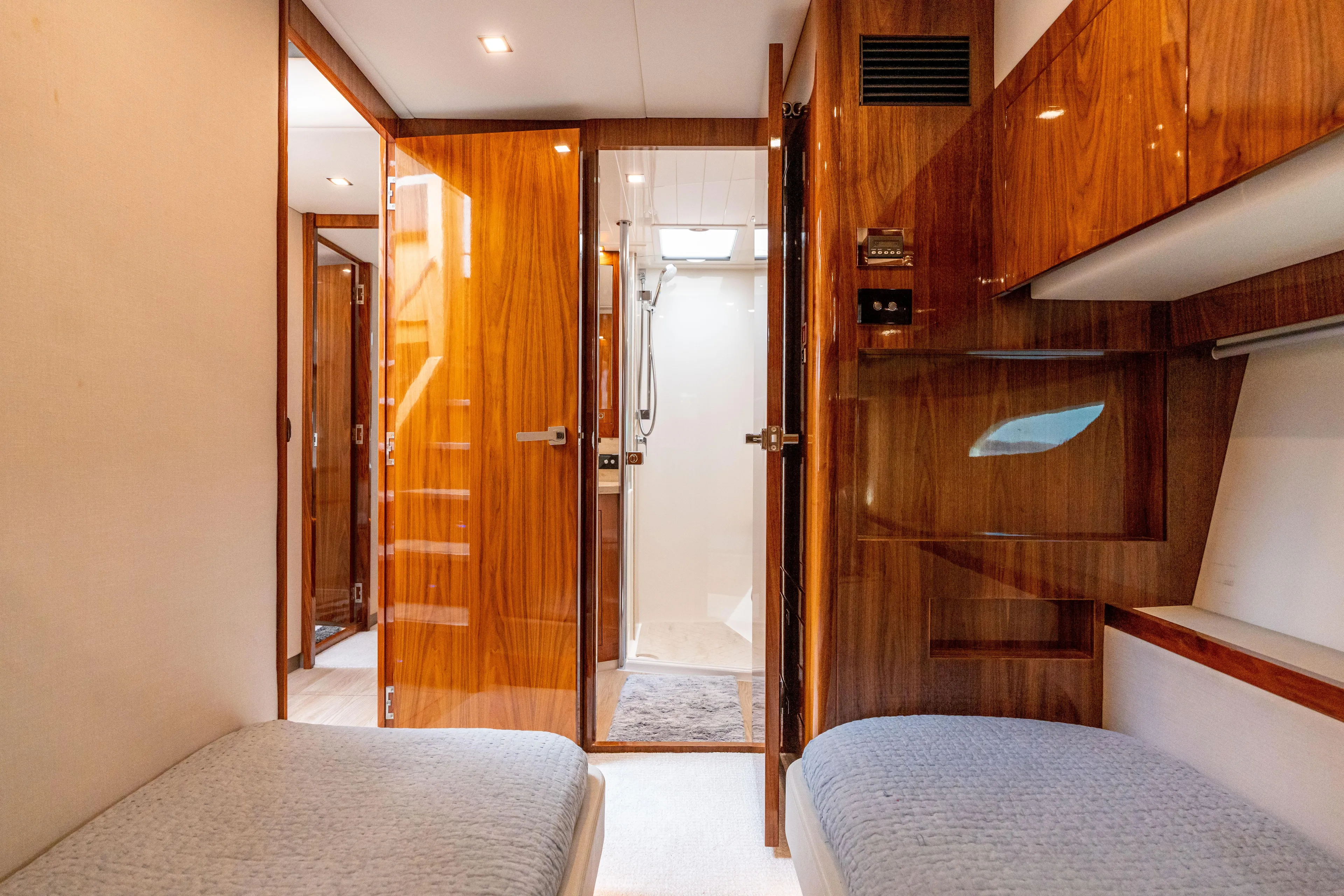 Change Happens Yacht Photos Pics Luxurious interior of 2017 Riviera 6000 Sport Yacht with wooden finishes and twin beds.