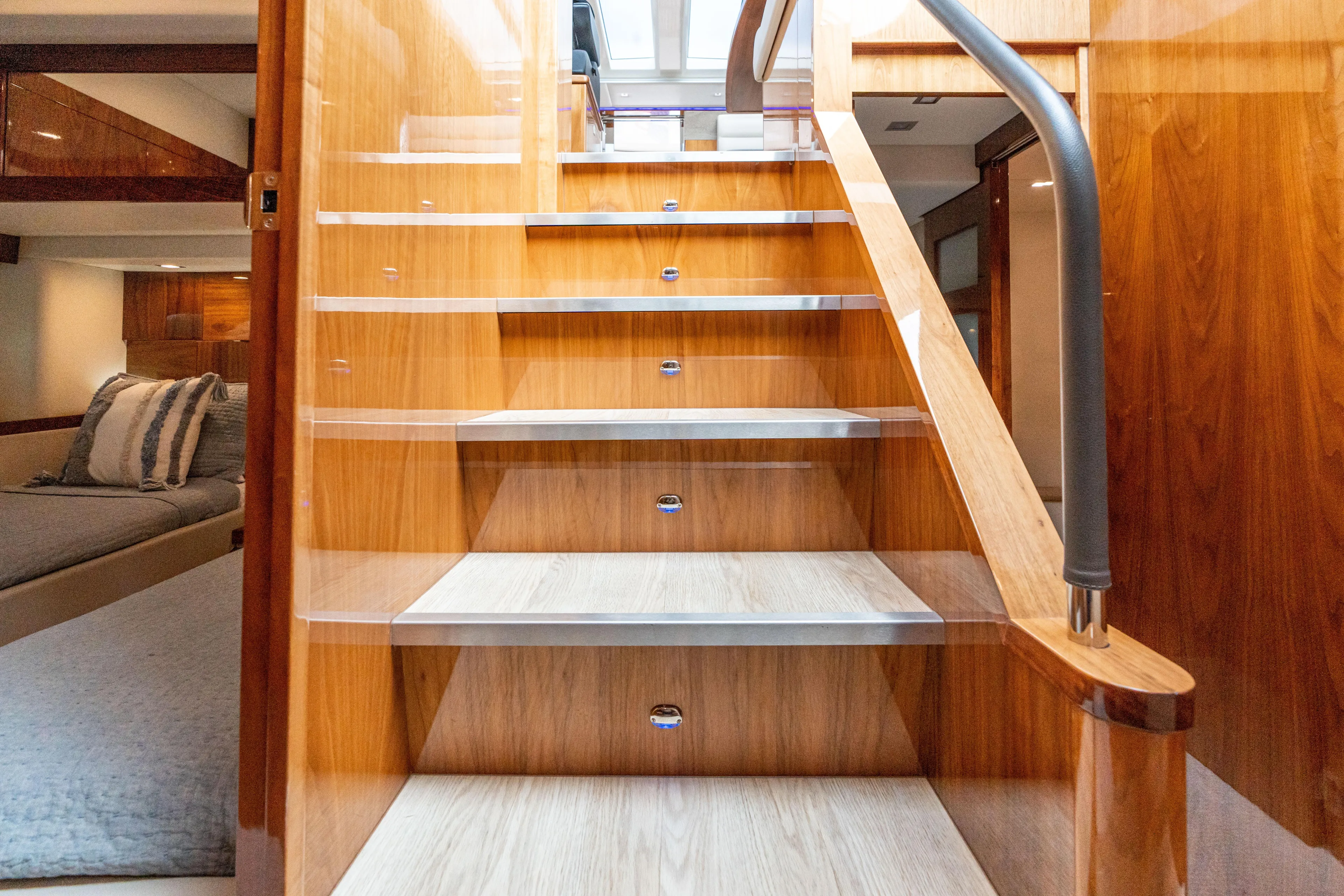 Change Happens Yacht Photos Pics Interior staircase of 2017 Riviera 6000 Sport Yacht, featuring elegant wood finish and modern design.