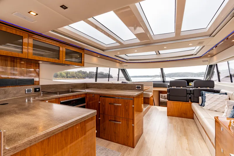 Change Happens Yacht Photos Pics Luxurious interior of 2017 Riviera 6000 Sport Yacht with modern kitchen and panoramic windows.