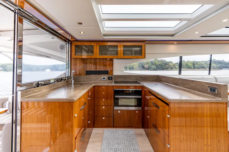 Change Happens Yacht Photos Pics Luxurious interior of 2017 Riviera 6000 Sport Yacht with modern kitchen and scenic windows.