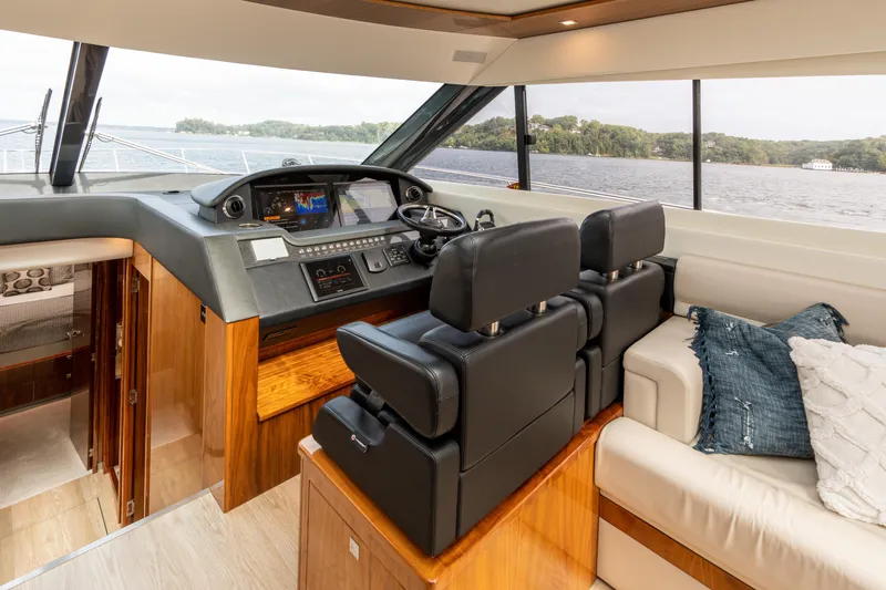 Change Happens Yacht Photos Pics Interior of 2017 Riviera 6000 Sport Yacht with luxurious helm and seating area.