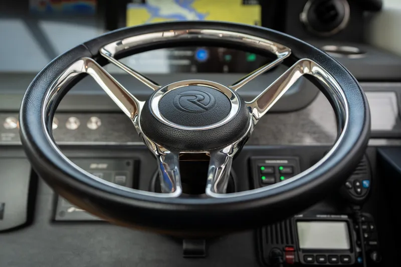 Change Happens Yacht Photos Pics Steering wheel of 2017 Riviera 6000 Sport Yacht, featuring sleek design and modern controls.