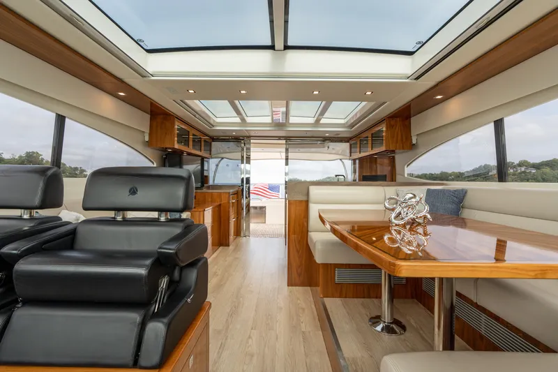 Change Happens Yacht Photos Pics Luxurious interior of 2017 Riviera 6000 Sport Yacht with elegant seating and wooden finishes.