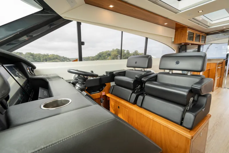 Change Happens Yacht Photos Pics Luxurious interior of 2017 Riviera 6000 Sport Yacht with leather seating and modern helm.